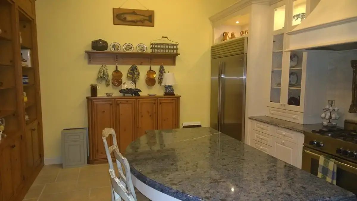 Professional cleaner wiping down surfaces in a residential kitchen