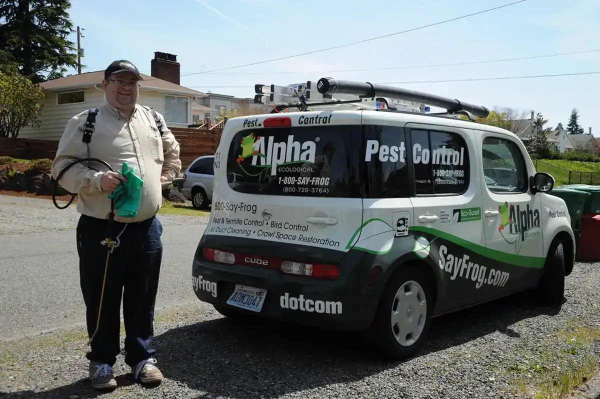 Pest control technician preparing treatment equipment at a residential property