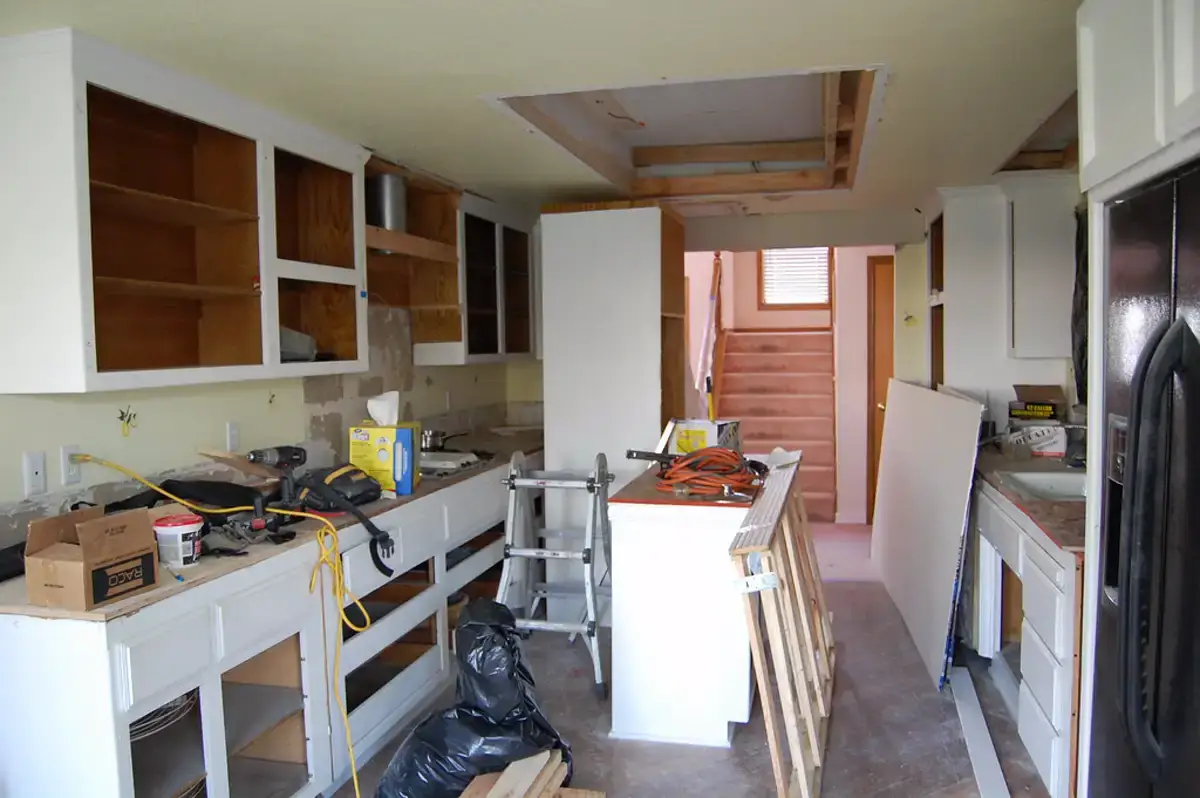 Contractor working on a residential kitchen remodel in progress